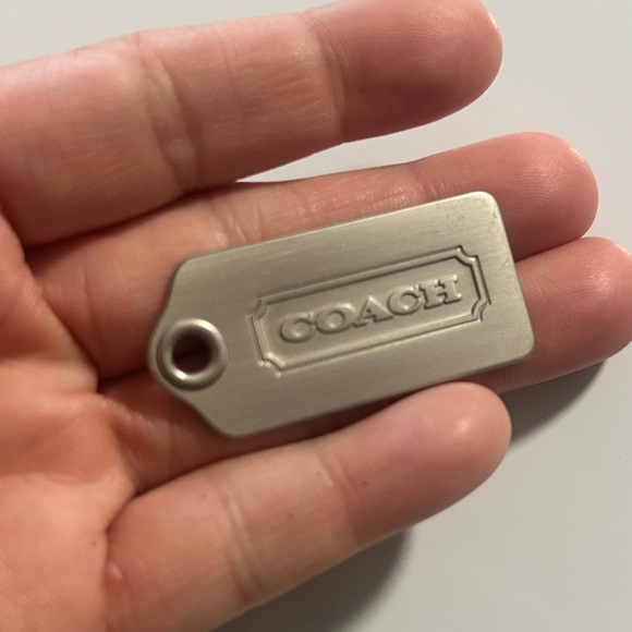 Coach Handbags - Coach Metallic Silver Phone Charm